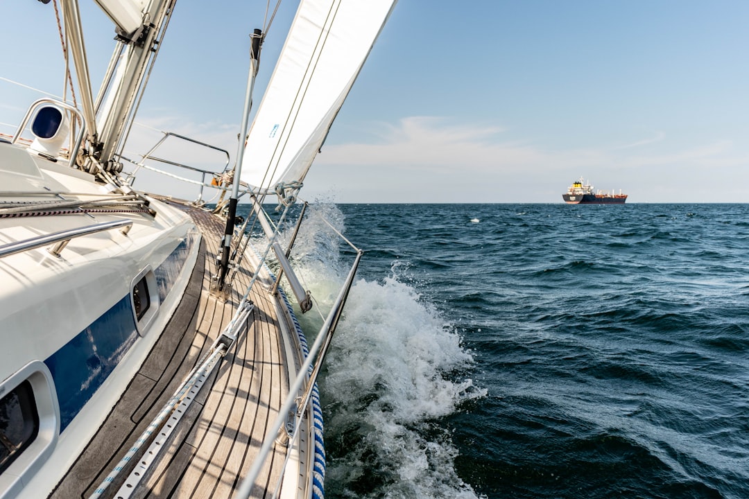 Applications Sailboat with canvas sail rigging out on open water