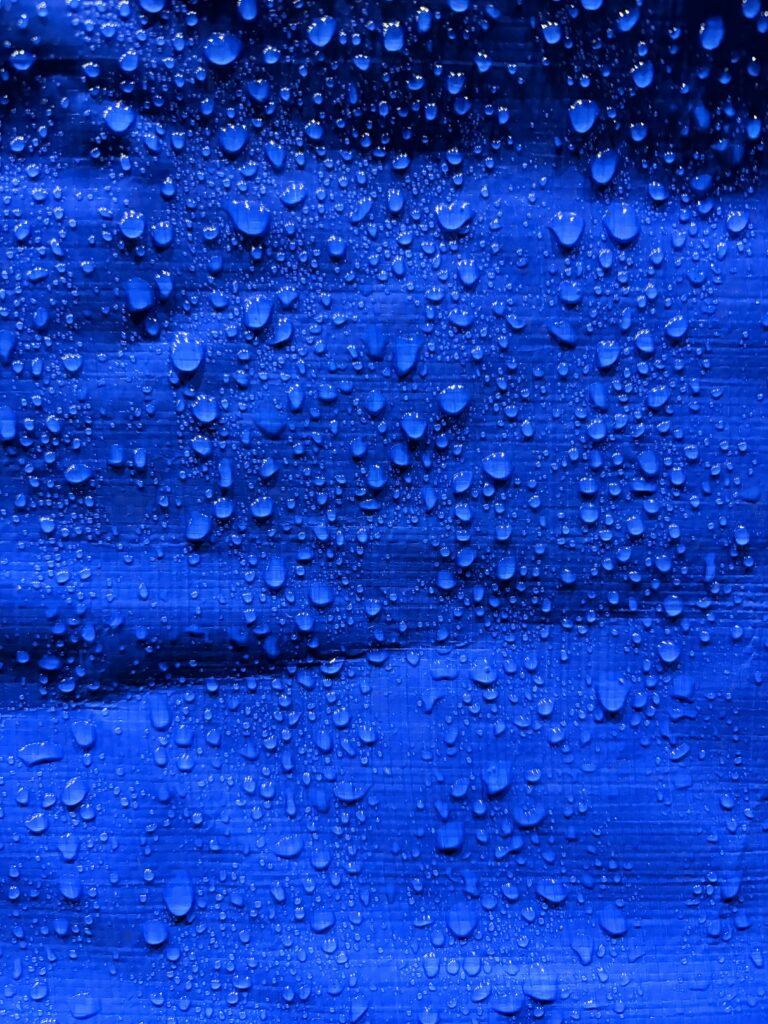 Water droplets on water repellent canvas fabric surface
