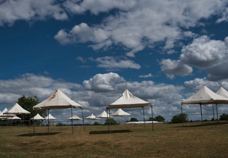 Shelters Row of canvas canopy shelters in an open field
